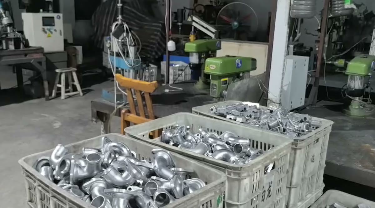Freshly cast metal components collected in workshop bins
